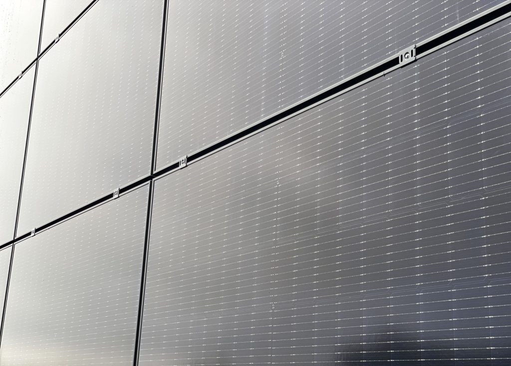Close-up of solar panels mounted on a metal facade.
