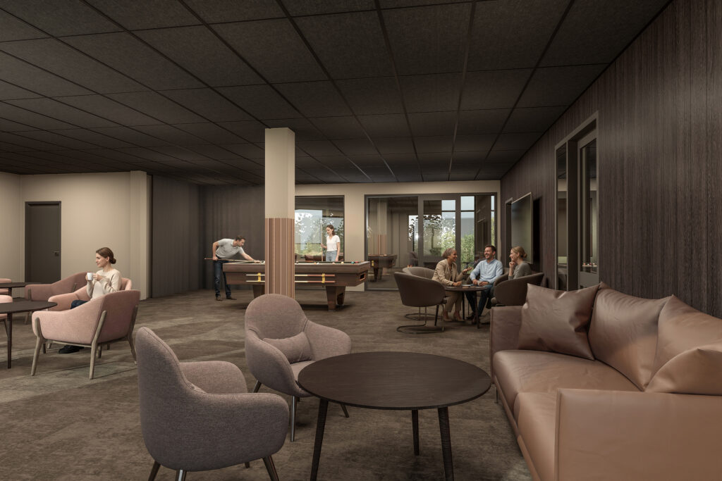 En trivsam gemenskapsyta med ett biljardbord i fokus där några personer samlas, pratar och spelar i ett rum med varma jordnära toner och mjukt ljus.