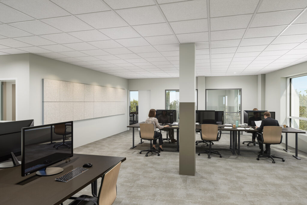 En ljus och luftig kontorsmiljö med öppna arbetsplatser där människor arbetar vid sina skrivbord omgivet av mjuka färger och generöst naturligt ljus.