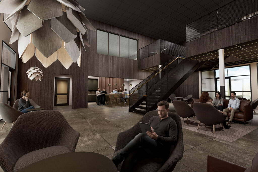 En lugn lounge i jordnära toner där människor sitter utspridda och arbetar i mjuka sittmöbler med ett stilla flöde av dagsljus i rummet.